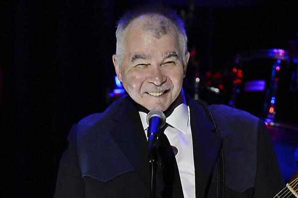 FILE - This Oct. 27, 2013 file photo shows country singer John Prine before singing "Ballad of a Teenage Queen" while honoring Country Music Hall of Fame inductee the late "Cowboy Jack Clement" at the ceremony for the 2013 inductions into the Country Music Hall of Fame in Nashville, Tenn. Prine says he’s been diagnosed with an operable form of lung cancer. A note on the 67-year-old website says he will undergo surgery next month, forcing the postponement two dates in Louisville, Ky. Prine says in the note that doctors found the cancer early and “see no reason why I won’t fully recover.” (AP Photo/Mark Zaleski, File)