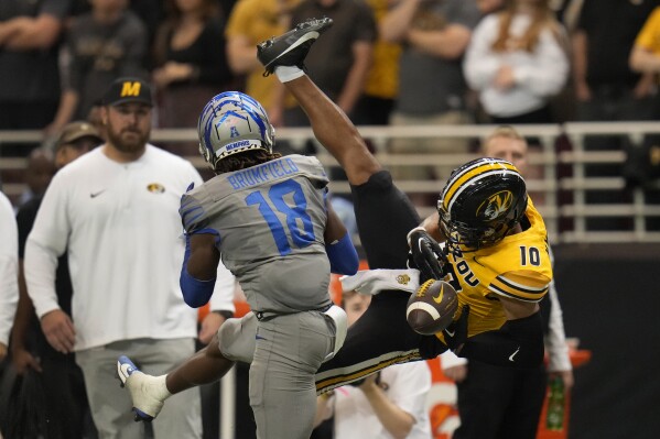 Missouri wide receiver Mekhi Miller (20) is unable to catch a pass as Memphis defensive back DeAgo Brumfield (18) defends during the second half of an NCAA college football game Saturday, Sept. 23, 2023, in St. Louis. (AP Photo/Jeff Roberson)