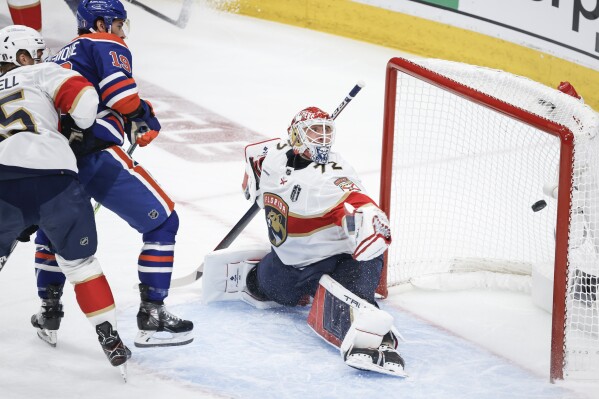 Florida Panthers goalie Sergei Bobrovsky (72) gives up a goal to Edmonton Oilers' Adam Henrique (19) during the first period of Game 4 of the NHL hockey Stanley Cup Final, Saturday, June 15, 2024, in Edmonton, Alberta. (Jeff McIntosh/The Canadian Press via AP)