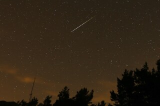 FILE - In this long exposure photo, a streak appears in the sky during the annual Perseid meteor shower at the Guadarrama mountains, near Madrid, in the early hours of Aug. 12, 2016. The best viewing for the annual shower visible around the world will be from Saturday night, Aug. 12, 2023, local time, into early Sunday morning, when viewers might be able to spot a meteor per minute. (AP Photo/Francisco Seco, File)