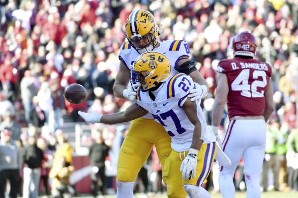 LSU running back Josh Williams (27) celebrates with teammate Mason Taylor (86) after scoring a touchdown against Arkansas during the second half of an NCAA college football game Saturday, Nov. 12, 2022, in Fayetteville, Ark. (AP Photo/Michael Woods)