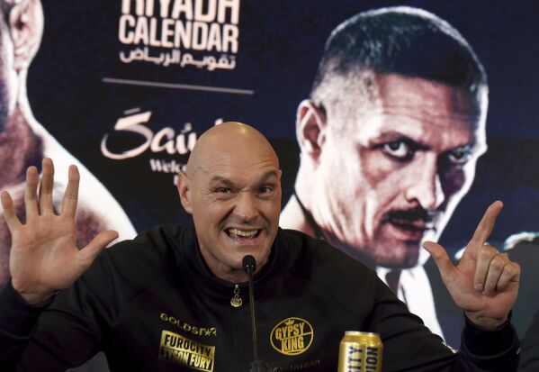 British professional boxer Tyson Fury gestures during a news conference at the The Mazuma Mobile Stadium, Morecambe, Wednesday, April 10, 2024. Tyson Fury says size will count for everything in his fight with Oleksandr Usyk to crown the first undisputed heavyweight champion since 2000. (Owen Humphreys/PA via AP)