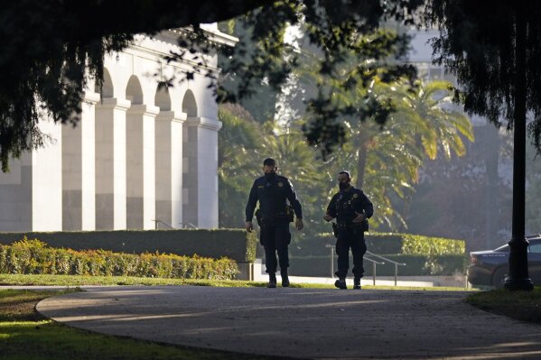 FILE - In this Jan. 14, 2021, file photo, California Highway Patrol officers patrol the grounds of the state Capitol in Sacramento, Calif. Law enforcement officials are investigating escalating threats of death and violence against California Gov. Gavin Newsom, his family and the the wineries, shops and other businesses he founded.  (AP Photo/Rich Pedroncelli, File)