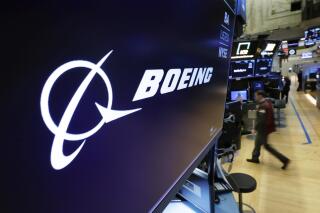 FILE - In this March 11, 2019 file photo, the Boeing logo appears above a trading post on the floor of the New York Stock Exchange. Saudi Arabia is buying up to 121 jetliners from Boeing in a big boost for the American manufacturer. The deal was expected to be announced Tuesday, March 14, 2023. (AP Photo/Richard Drew, File)