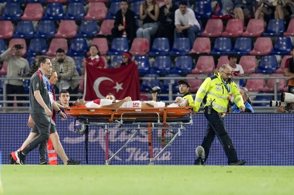 Turkey's Ozan Kabak is carried injured out of the pitch by medical staff during the international friendly soccer match between Italy and Turkey at the Renato Dall'Ara stadium in Bologna, Italy, Tuesday, June 4, 2024. (AP Photo/Antonio Calanni)
