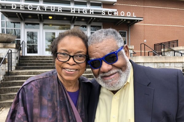 In this Feb. 13, 2020 photo, Roslyn Pope, who wrote "An Appeal for Human Rights" as a Spelman College student in March 1960, and Charles Black, who co-founded the Atlanta Student Movement as a Morehouse College student that year, pose outside Decatur High School in Decatur, Ga. For the movement's 60th anniversary, Pope and Black spoke at the high school about their efforts to hasten the end of racial segregation in the South. (AP Photo/Michael Warren)