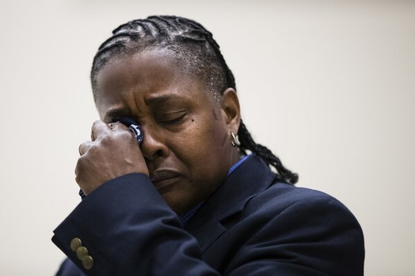 
              Paulette Carrington, a participant in Uplift Solutions' job training program for former inmates, wipes her eyes as she speaks during a graduation ceremony in Philadelphia, Monday, Oct. 16, 2017. Carrington was convicted of killing the 15-year-old son of her father’s girlfriend. Carrington said the woman had cut her face with a pocket razor during an argument. Not long after, Carrington said she lashed out with a knife when the other teen threatened to tell his mother Carrington had come home late. (AP Photo/Matt Rourke)
            