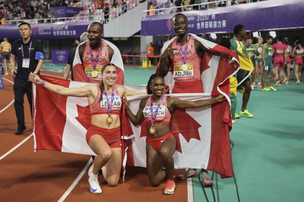 Canada sprinters from left; Duan Asemota, Marie-ÉLoise Leclair, Sade Mccreath, and Eliezer Adjibi celebrate after winning the gold medals in 4x100 meters mixed relay at the World Athletics Relay, in Guangzhou in south China's Guangdong province on Sunday, May 11, 2025. (Chinatopix Via AP)