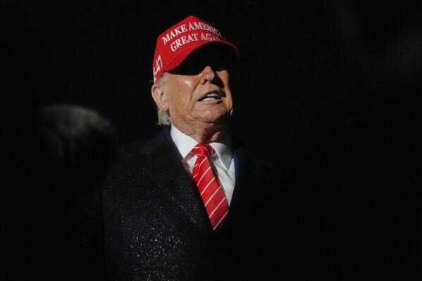 President Donald Trump speaks to reporters in the rain after arriving on Air Force One at Joint Base Andrews, Md., Friday, May 30, 2025. (AP Photo/Julia Demaree Nikhinson)