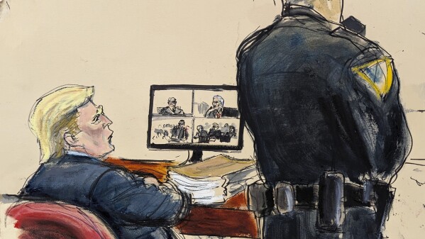 Former President Donald Trump sits at the defense table while David Pecker, shown on the video screen, testifies about Karen McDougal in Manhattan criminal court, Tuesday, April 23, 2024, in New York. (Elizabeth Williams via AP)