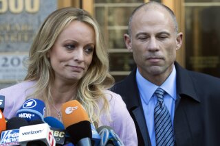 
              FILE - In this April 16, 2018 file photo, adult film actress Stormy Daniels, left, stands with her lawyer Michael Avenatti as she speaks outside federal court, in New York. Avenatti,...