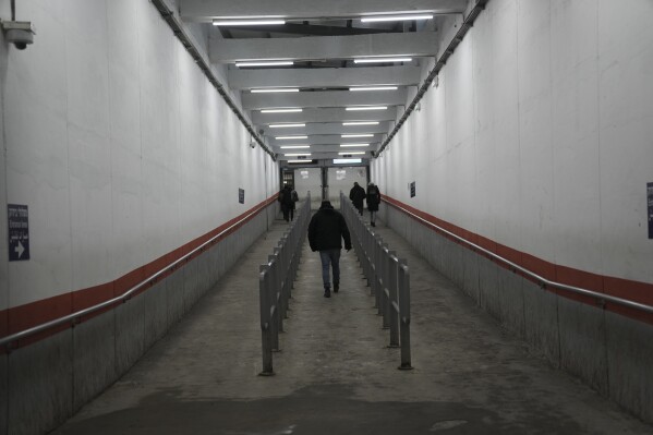 Palestinians cross into Israel through a checkpoint in Bethlehem, West Bank, on Wednesday, Feb. 7, 2024. (AP Photo/Mahmoud Illean)