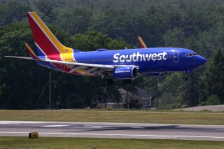 FILE - Southwest Airlines Boeing 737 lands at Manchester Boston Regional Airport, June 2, 2023, in Manchester, N.H. Southwest Airlines is changing its unusual boarding system by limiting the opportunity to pay an extra fee and jump ahead of other passengers in the race for the best seats. The airline said Wednesday, Aug. 23, that it has not dropped “EarlyBird” entirely from any flights, but it is “limiting the number of spots available for purchase on certain flights, routes, or days, as we work on product enhancements.” (AP Photo/Charles Krupa, File)
