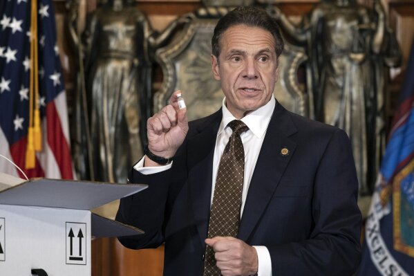 In this Dec. 3, 2020, photo provided by the Office of Gov. Andrew Cuomo, Cuomo holds up samples of empty packaging for the COVID-19 vaccine during a news conference in the Red Room at the State Capitol in Albany, N.Y.  Cuomo is one of several contenders under consideration by President-elect Joe Biden for the role of attorney general. (Mike Groll/Office of Governor of Andrew M. Cuomo via AP)