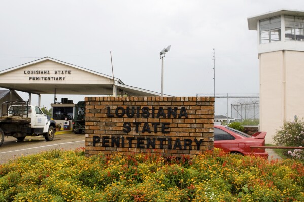 FILE - Vehicles enter at the main security gate at the Louisiana State Penitentiary — the Angola Prison, the largest high-security prison in the country in Angola, La., Aug. 5, 2008. A person found guilty of a sex crime against a child in Louisiana could soon be ordered to undergo surgical castration, in addition to prison time. Louisiana lawmakers gave final approval to a bill Monday, June 3, 2024 that would allow judges the option to sentence someone to surgical castration after the person has been convicted of certain aggravated sex crimes — including rape, incest and molestation — against a child younger than 13. (AP Photo/Judi Bottoni, File)