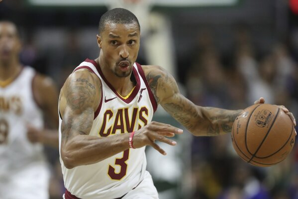 
              FILE - In this Oct. 12, 2018, file photo, Cleveland Cavaliers guard George Hill brings the ball up during the second half of the team's NBA preseason basketball game against the Detroit Pistons in East Lansing, Mich. A person familiar with the trade says the Cavaliers have agreed to acquire guard Matthew Dellavedova, forward John Henson and two draft picks in 2021 from the Milwaukee Bucks in exchange for Hill and forward Sam Dekker. (AP Photo/Carlos Osorio, File)
            
