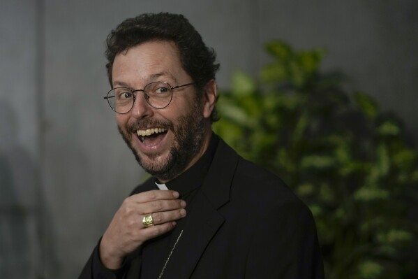 FILE - Newly named cardinal Giorgio Marengo poses for a photo, during a press conference at the Vatican, Saturday, Aug. 27, 2022. The young cardinal in charge of Mongolia’s tiny Catholic community said Monday, July 17, 2023 that the faithful there were thrilled Pope Francis is making the first-ever papal visit to Mongolia, saying it’s evidence of his willingness to travel to the farthest corners of the globe to minister to just a few hundred members of his flock. (AP Photo/Andrew Medichini, File)