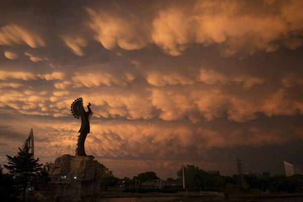 A formation of Mammatus clouds fills the sky over Wichita, Kan., on Tuesday, April 30, 2024. Mammatus clouds usually form on the back side of severe thunderstorms. A line of severe storms crossed the state Tuesday afternoon and evening, including a few tornados in the northeastern part of Kansas. (Travis Heying/The Wichita Eagle via AP)
