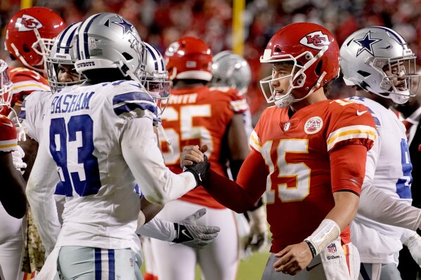 Kansas City Chiefs quarterback Patrick Mahomes (15) and Dallas Cowboys defensive end Tarell Basham (93) greet each other after an NFL football game, Sunday, Nov. 21, 2021, in Kansas City, Mo. (AP Photo/Charlie Riedel, File)