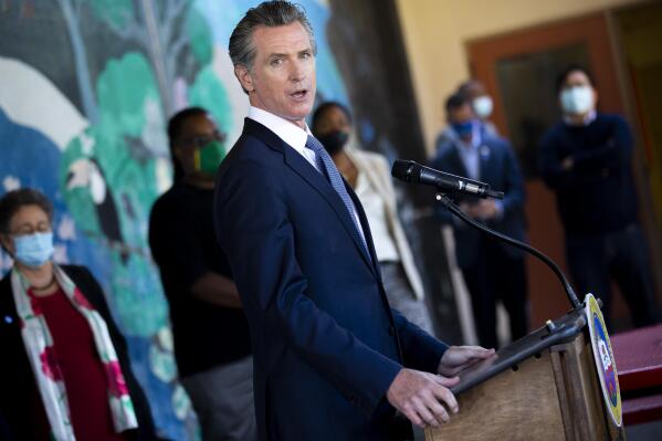 FILE - In this Aug. 11, 2021, file photo, California Gov. Gavin Newsom speaks with reporters at Carl B. Munck Elementary School in Oakland, Calif. Newsom has sharpened his message in the recall's final month and is focusing his attention on conservative rival Larry Elder, who has pledged to end California's mask mandate. The last day to vote is Sept. 14. (Santiago Mejia/San Francisco Chronicle via AP, Pool, File)