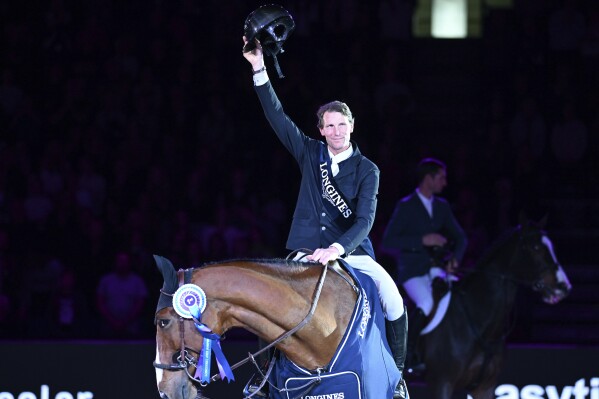 FILE - France's Kevin Staut on horse Beau de Laubry Z gestures, during the 37th International Show Jumping Grand Prix of Stuttgart in Stuttgart, Germany, Sunday, Nov. 19, 2023. Former equestrian Olympic gold medallist Kevin Staut was cleared Thursday, Feb. 22, 2024, by a French court of assaulting his former partner during a brawl in a hotel room, his lawyer told The Associated Press. (Bernd Wei'brod/dpa via AP, File)