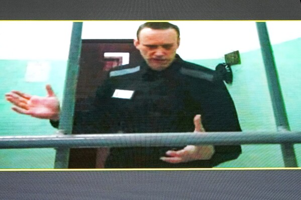 FILE Russian opposition leader Alexei Navalny is seen on a TV screen as he appears in a video link provided by the Russian Federal Penitentiary Service from the colony in Melekhovo, Vladimir region, during a hearing at the Russian Supreme Court in Moscow, Russia, Thursday, June 22, 2023. A court in Russia has upheld a 19 year prison sentence against imprisoned Russian opposition leader Alexei Navalny. He was found guilty of charges of extremism at a hearing in August. (AP Photo/Alexander Zemlianichenko, File)