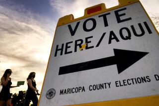 FILE - Voters deliver their ballot to a polling station in Tempe, Ariz., Nov. 3, 2020. Social media users have falsely claimed that Arizona’s Maricopa County accepted 18,000 ballots after election day. (AP Photo/Matt York, File)