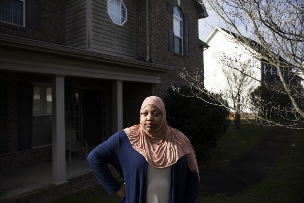 Imani Mfalme poses for a portrait outside her late mother's house Thursday, March 7, 2024, in Knoxville, Tenn. Mfalme's mother suffered from Alzheimer's and was placed in long term care. After her death the state is now trying to lay claim to the estate to pay for that care. (AP Photo/Caitie McMekin)