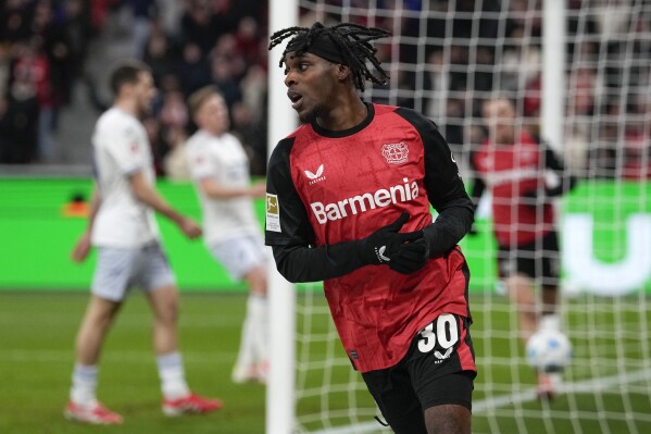 Leverkusen's Jeremie Frimpong celebrates after he scored his side's second goal during the German Bundesliga soccer match between Bayer Leverkusen and TSG Hoffenheim at the BayArena in Leverkusen, Germany, Sunday, Feb. 2, 2025. (AP Photo/Martin Meissner, File)