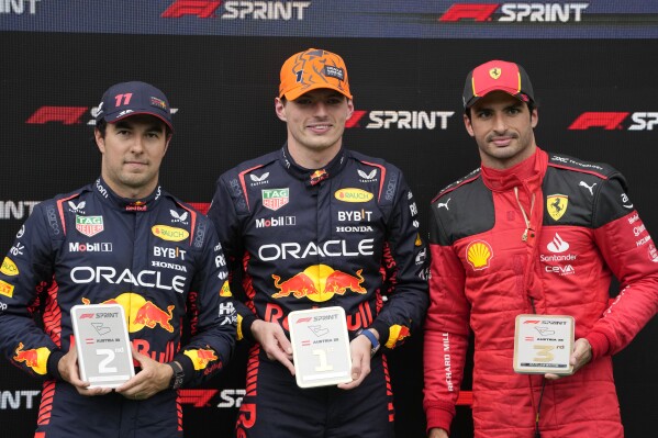 Race winner Red Bull driver Max Verstappen of the Netherlands, center, second placed Red Bull driver Sergio Perez of Mexico, left, and Ferrari driver Carlos Sainz of Spain pose for photograph on the podium of a sprint race, at the Red Bull Ring racetrack, in Spielberg, Austria, Saturday, July 1, 2023. The Formula One Austrian Grand Prix will be held on Sunday, July 2, 2023. (AP Photo/Darko Bandic)
