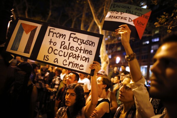FILE - Demonstrators from a nearby pro-Palestinian rally join a protest in New York on Wednesday, Aug. 20, 2014 against the police shooting death of Michael Brown in Ferguson, Mo. (AP Photo/Jason DeCrow, File)