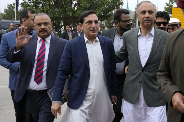 Pakistan's newly elected lawmakers backed by imprisoned former Prime Minister Imran Khan's party, from left to right, Aamir Dogar, Gohar Khan and Omar Ayub arrive to attend the opening session of parliament, in Islamabad, Pakistan, Thursday, Feb. 29, 2024. Pakistan's National Assembly swore in newly elected members on Thursday in a chaotic scene, as allies of jailed former Premier Khan protested what they claim was a rigged election. (AP Photo/Anjum Naveed)