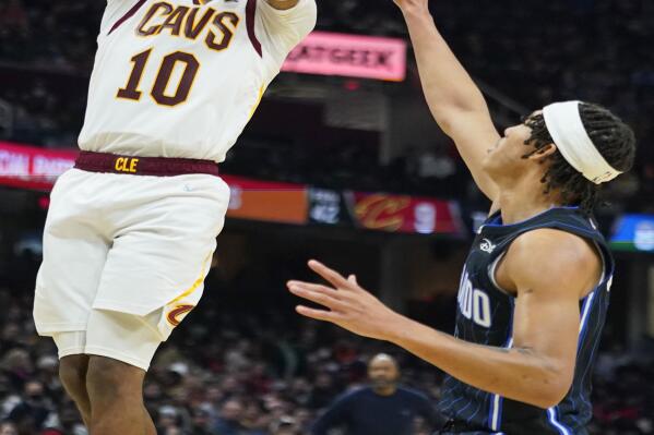 Cleveland Cavaliers' Darius Garland (10) shoots against Orlando Magic's R.J. Hampton (13) in the second half of an NBA basketball game, Saturday, Nov. 27, 2021, in Cleveland. The Cavaliers won 105-92. (AP Photo/Tony Dejak)