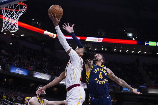 Cleveland Cavaliers guard Darius Garland (10) shoots in front of Indiana Pacers guard Duane Washington Jr. (4) during the first half of an NBA basketball game in Indianapolis, Tuesday, March 8, 2022. The Cavaliers won 127-124. (AP Photo/Michael Conroy)