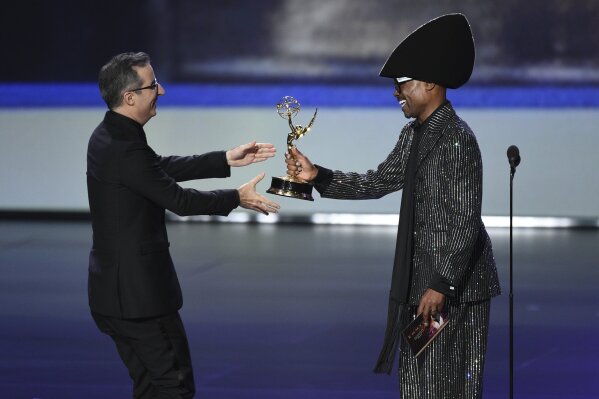 John Oliver, left, accepts the award for outstanding variety talk series from Billy Porter at the 71st Primetime Emmy Awards on Sunday, Sept. 22, 2019, at the Microsoft Theater in Los Angeles. (Photo by Chris Pizzello/Invision/AP)
