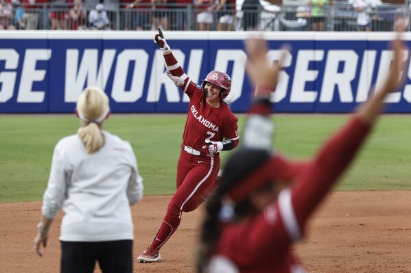 Oklahoma's Kasidi Pickering (7) celebrates a home run against Texas during the second inning of Game 2 of the NCAA Women's College World Series softball championship series Thursday, June 6, 2024, in Oklahoma City. (AP Photo/Alonzo Adams)