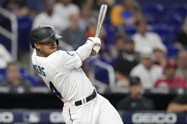 Miami Marlins' Jean Segura (9) hits a single to score the winning run  during the ninth inning of a baseball game against the Chicago Cubs,  Friday, April 28, 2023, in Miami. The