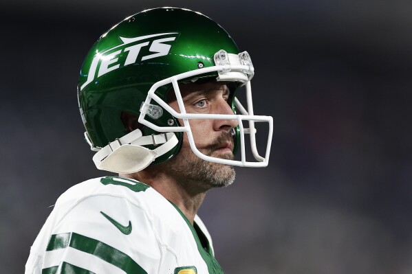 FILE - New York Jets quarterback Aaron Rodgers warms up before playing against the Buffalo Bills in an NFL football game, Sept. 11, 2023, in East Rutherford, N.J. Rodgers spoke to local reporters Thursday, Nov. 30, and said he's not yet close to being able to play after tearing his left Achilles tendon four snaps into his debut with the Jets on Sept. 11. But he also left open the door for him to be back under center before his initial goal of Dec. 24, saying he plans to ramp up his practice activities next week. (AP Photo/Adam Hunger, File)