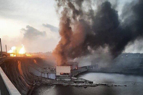 In this photo provided by Telegram Channel of Ukraine's Prime Minister Denys Shmyhal, smoke and fire rise over the Dnipro hydroelectric power plant after Russian attacks in Dnipro, Ukraine, Friday, March 22, 2024. (Telegram Channel of Ukraine's Prime Minister Denys Shmyhal via AP)