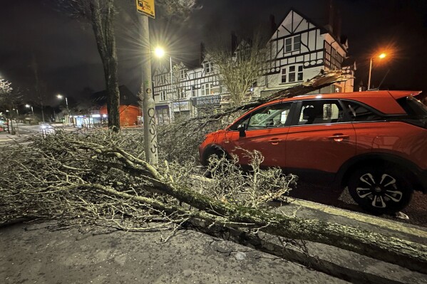 A tree branch fallen on a car on Lisburn Road in Belfast, Northern Ireland, during Storm Isha, on Sunday, Jan. 21, 2024. A Status Red wind warning has been issued for counties Donegal, Galway and Mayo as authorities warn people to take care ahead of Storm Isha's arrival. (Liam McBurney/PA via AP)