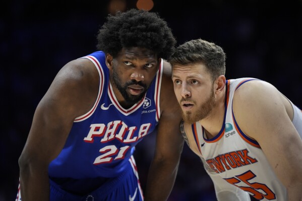 Philadelphia 76ers' Joel Embiid, left, and New York Knicks' Isaiah Hartenstein, right, guard against each other during the second half of Game 6 in an NBA basketball first-round playoff series, Thursday, May 2, 2024, in Philadelphia. (AP Photo/Matt Slocum)
