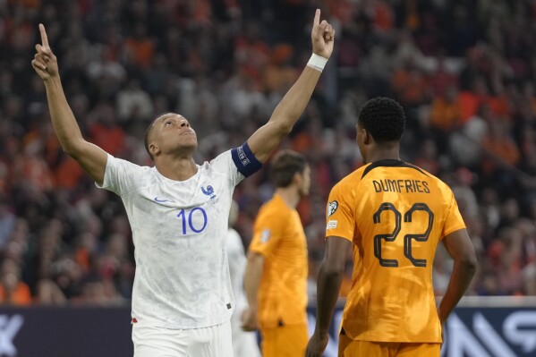 France's Kylian Mbappe celebrates after scoring his side's opening goal during the Euro 2024 group B qualifying soccer match between The Netherlands and France at the Johan Cruyff ArenA stadium in Amsterdam, Netherlands, Friday, Oct. 13, 2023. (AP Photo/Peter Dejong)