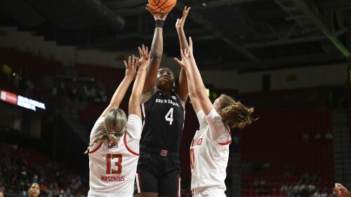 South Carolina's Aliyah Boston shoots between Maryland's Faith Masonius, left, and Abby Meyers during the first half of an NCAA college basketball game Friday, Nov. 11, 2022, in College Park, Md. (AP Photo/Gail Burton)