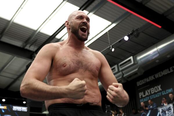 British boxer Tyson Fury attends an open workout for the media and fans at Wembley's Boxpark in London, Tuesday, April 19, 2022. Fury will defend his WBC heavyweight title against Dillian Whyte at Wembley Stadium Saturday. (AP Photo/Ian Walton)