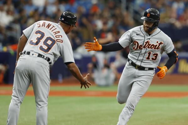 Detroit Tigers' Eric Haase (13) celebrates with third base coach Ramon Santiago after hitting a home run against the Tampa Bay Rays during the fourth inning of a baseball game Sunday, Sept. 19, 2021 in St. Petersburg, Fla. (AP Photo/Scott Audette)