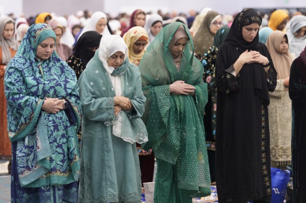 American Muslim women pray to mark the end of the holy month of Ramadan at Petree Hall in Los Angeles Wednesday, April 10, 2024. (AP Photo/Damian Dovarganes)