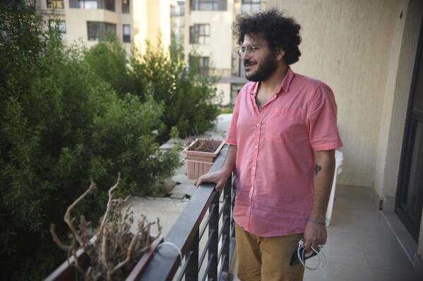 Patrick George Zaki, an activist and postgraduate student in Italy, poses during an interview with The Associated Press at his home in Cairo, Egypt, Friday July 21, 2023, following his release from prison. Zaki, who received a presidential pardon on Wednesday, said he hopes that other prominent jailed dissidents would be let go soon, including one of the most famous, Alaa Abdel Fattah. (AP Photo/Tarek Wajeh)