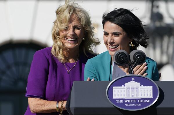 First lady Jill Biden comes over to comfort 2021 National Teacher of the Year Juliana Urtubey, a bilingual special education teacher in Las Vegas, who was emotional as she spoke during an event with 2020 and 2021 State and National Teachers of the Year on the South Lawn of the White House in Washington, Monday, Oct. 18, 2021. (AP Photo/Susan Walsh)