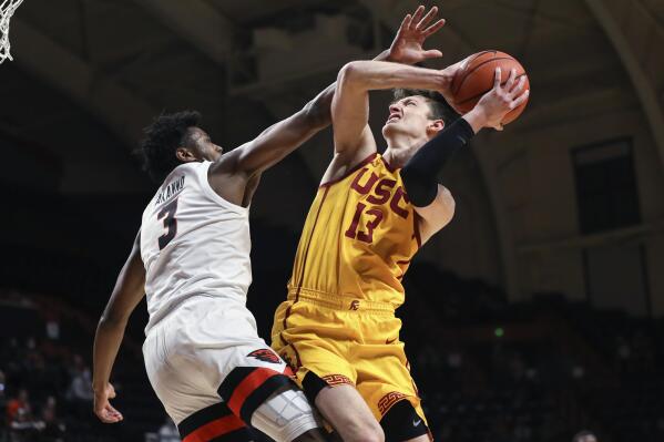 Southern California guard Drew Peterson is fouled by Oregon State guard Dexter Akanno during the second half of an NCAA college basketball game Thursday, Feb. 24, 2022, in Corvallis, Ore. Southern California won 94-91. (AP Photo/Amanda Loman)