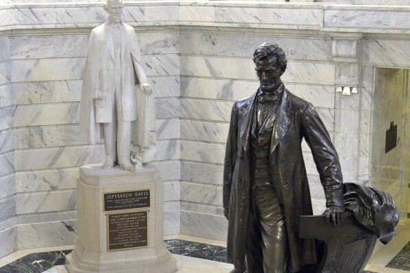 FILE - A statue of Jefferson Davis, left, looks towards a statue of Abraham Lincoln in the Rotunda of the Kentucky State Capitol in Frankfort, Ky., Aug. 5, 2015. Kentucky lawmakers would claim authority over what statues are installed or removed from the state Capitol's Rotunda under a bill passed Friday, March 1, 2024, by the GOP-led House, a move the bill sponsor said has nothing to do with the removal of a statue of Confederate President Jefferson Davis. (APPhoto/Timothy D. Easley, File)